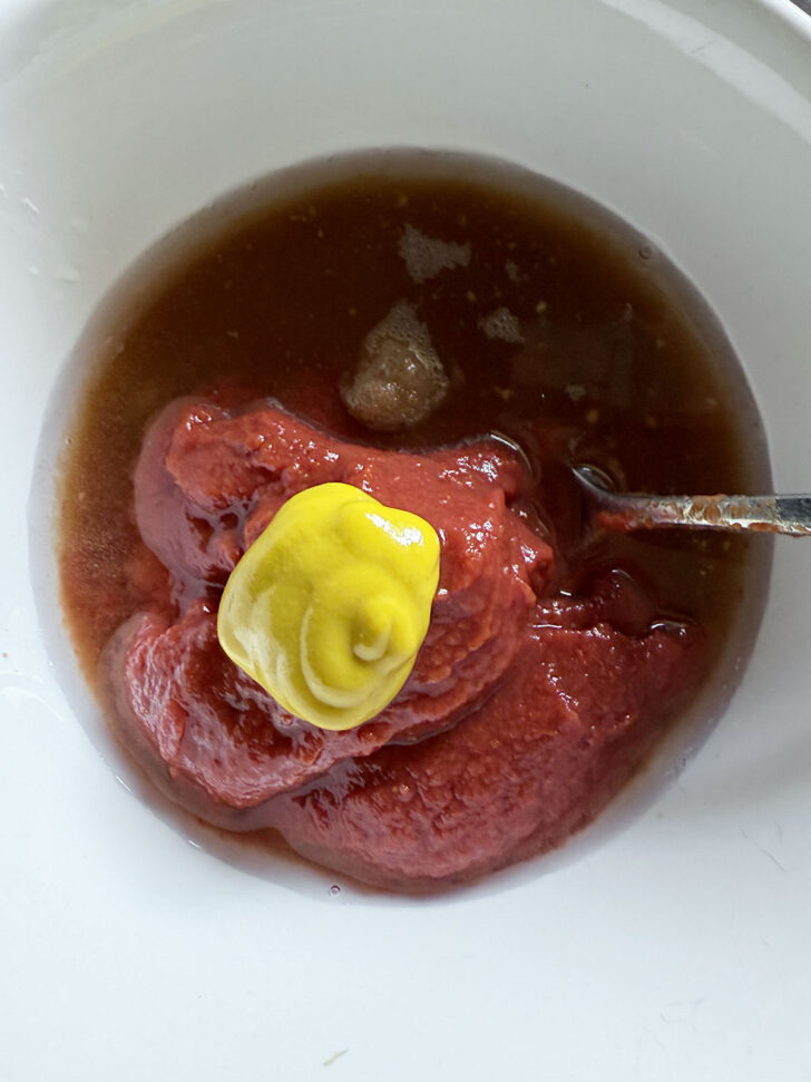 Mixing up the tomato sauce for the meatloaf in a small bowl.