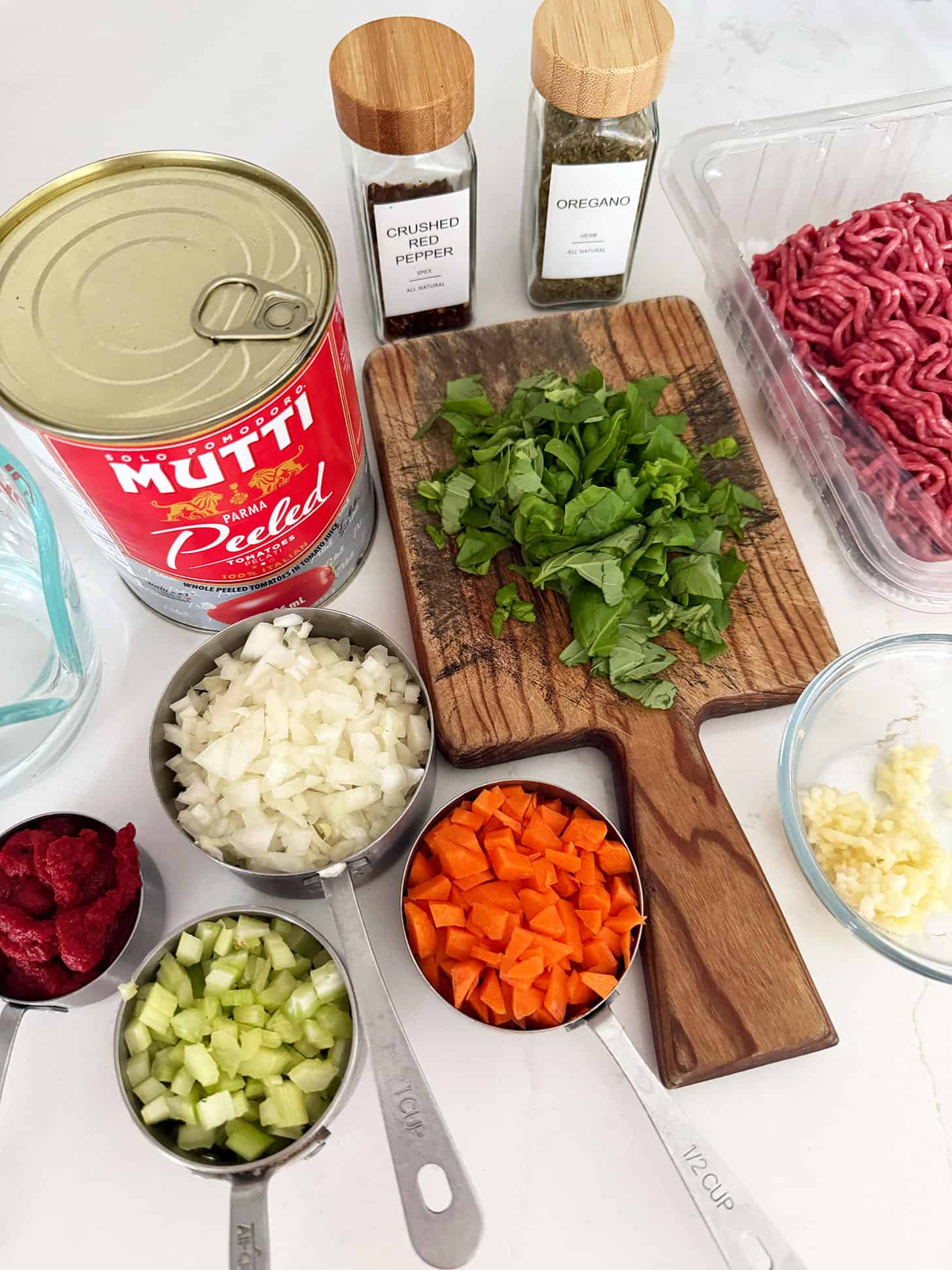 Ingredients for classic Italian meat sauce prepped on the counter.
