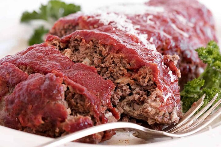 classic meatloaf sliced on white plate