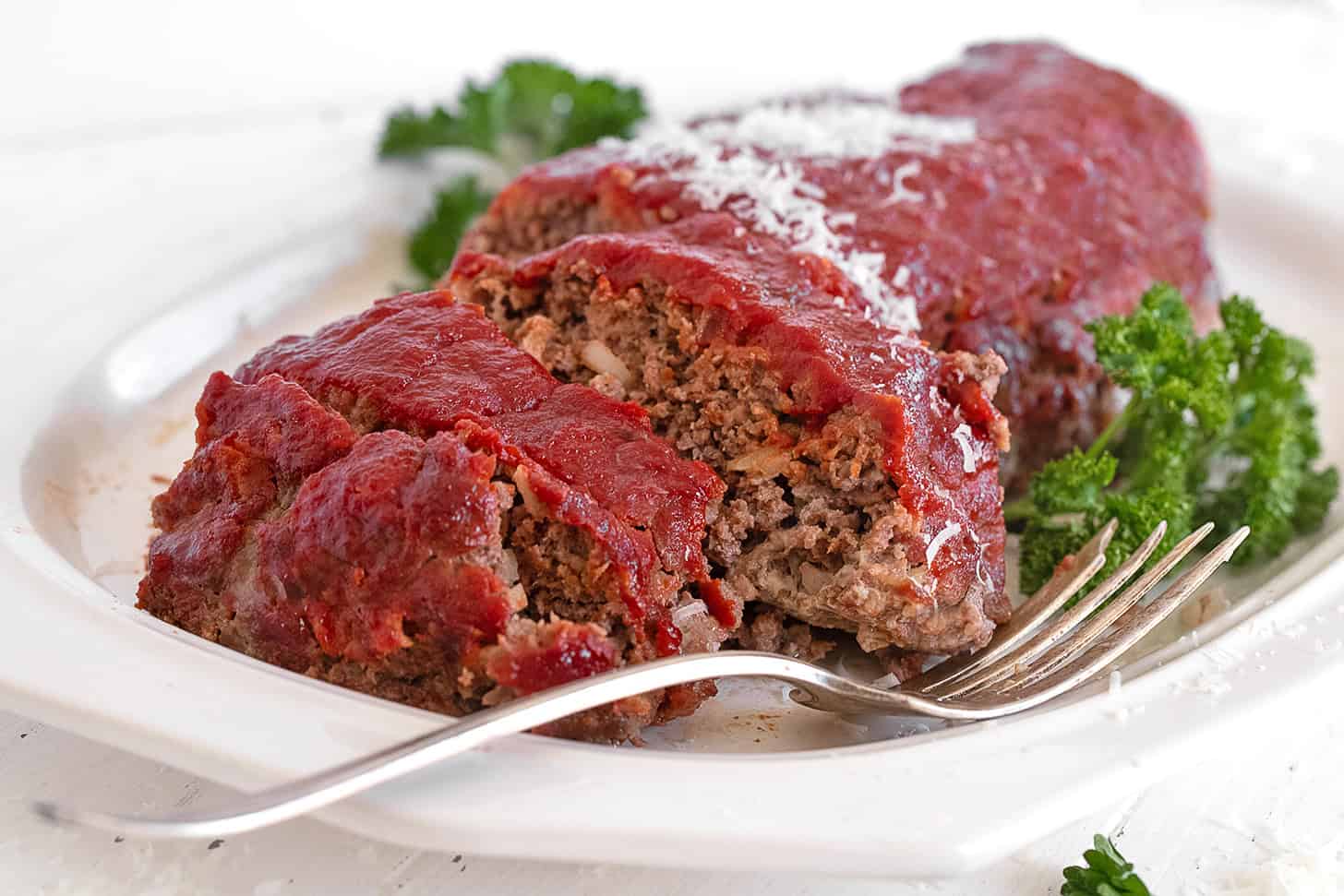 Classic meatloaf sliced on a serving platter.