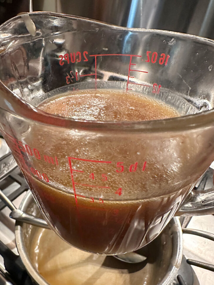 finished caramel sauce in a measuring cup