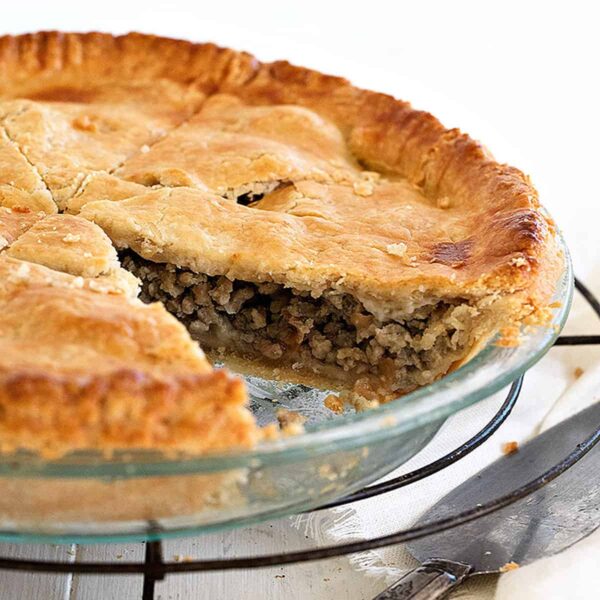 classic tourtiere in pie pan sliced
