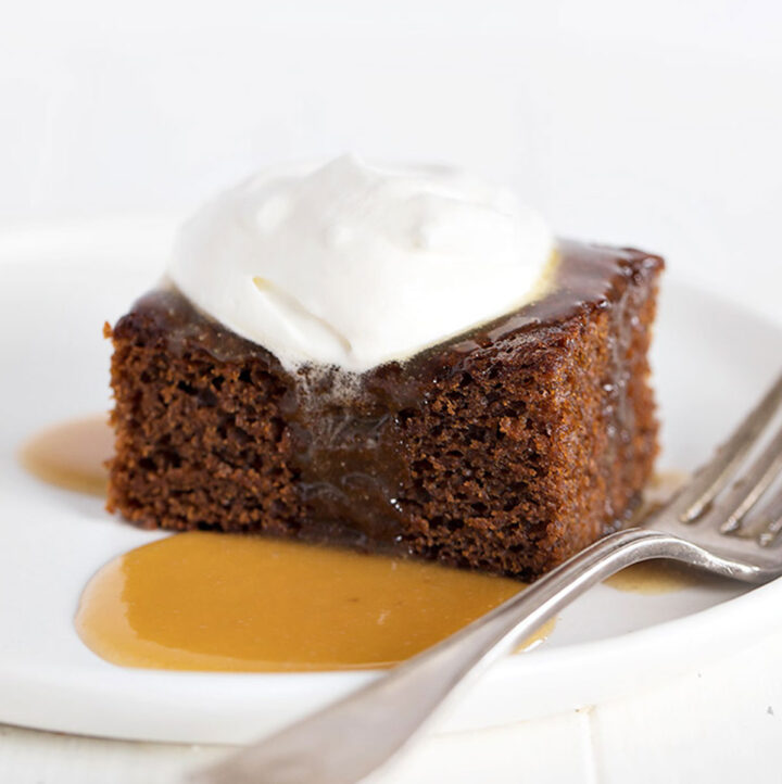 Classic Gingerbread Cake with whipped cream topping and caramel sauce