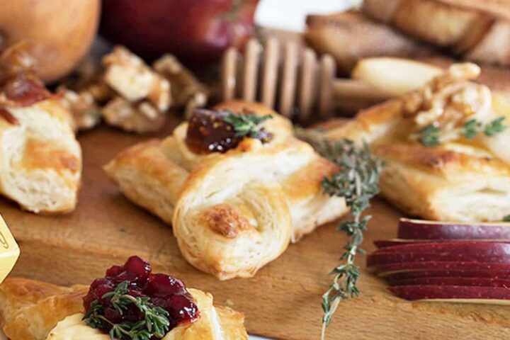 spreadable brie puff pastries with jam on cutting board