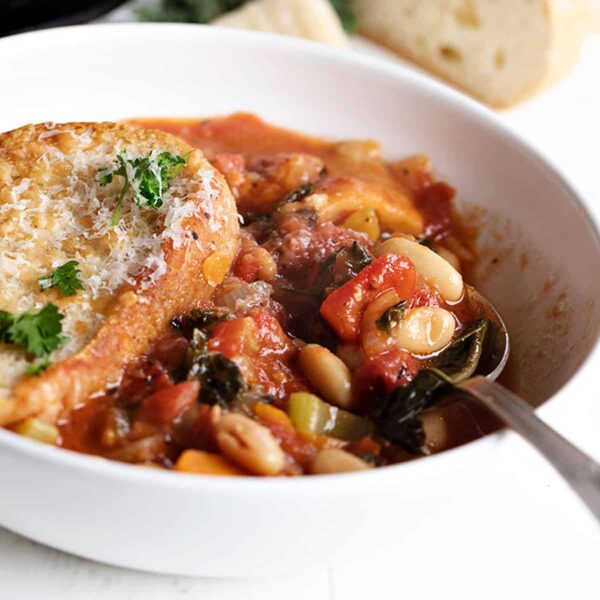 ribollita soup in white bowl with spoon
