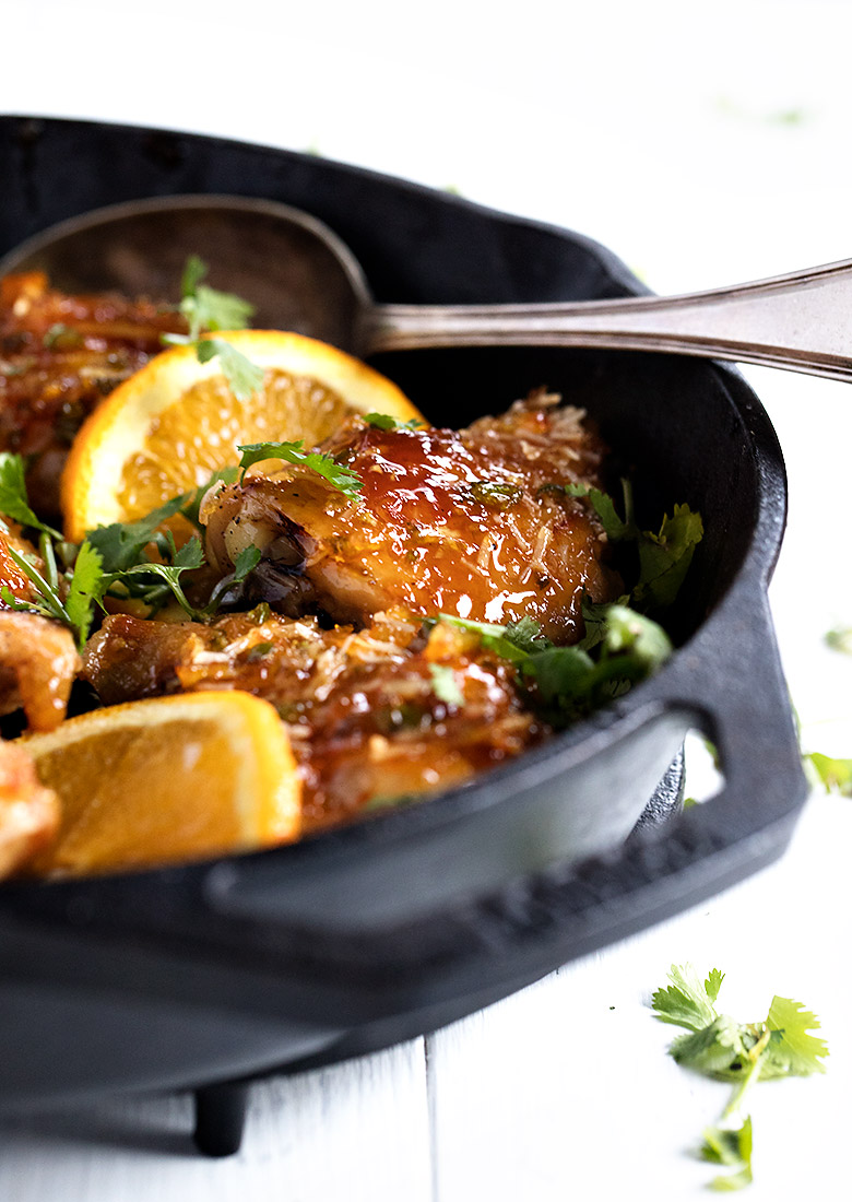 orange glazed chicken thighs in cast iron skillet