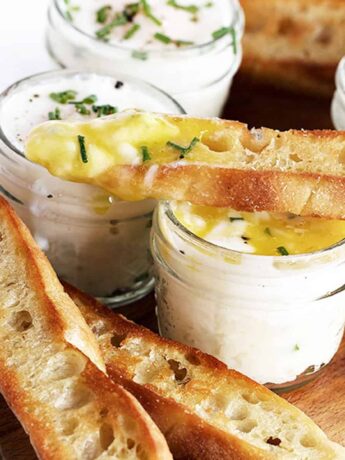 coddled eggs in small jars with mashed potatoes