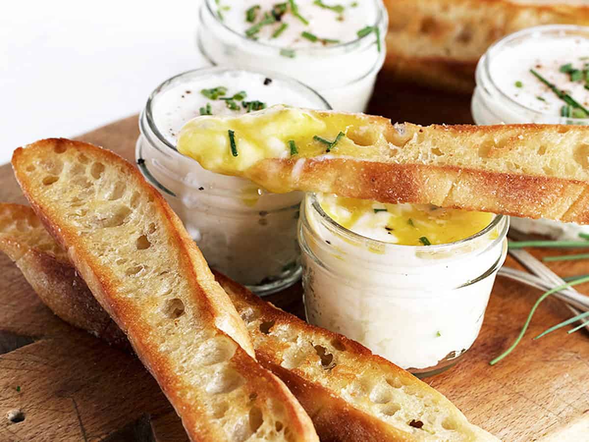 coddled eggs in small jars with mashed potatoes