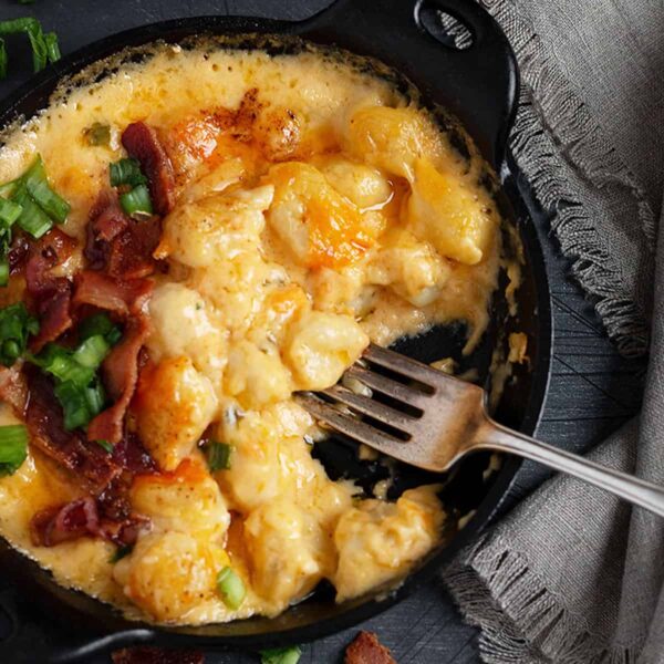 gnocchi and cheese with bacon in cast iron skillet