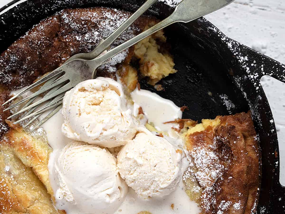 bananas foster Dutch baby pancake in skillet with ice cream