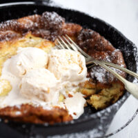 bananas foster Dutch baby in cast iron skillet with ice cream