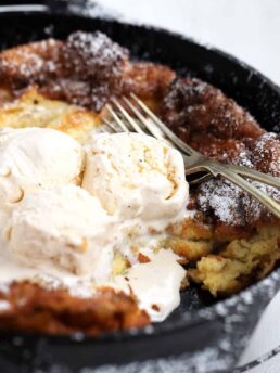 bananas foster Dutch baby in cast iron skillet with ice cream