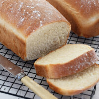 homemade white bread sliced on cooling rack