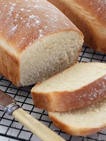 homemade white bread sliced on cooling rack