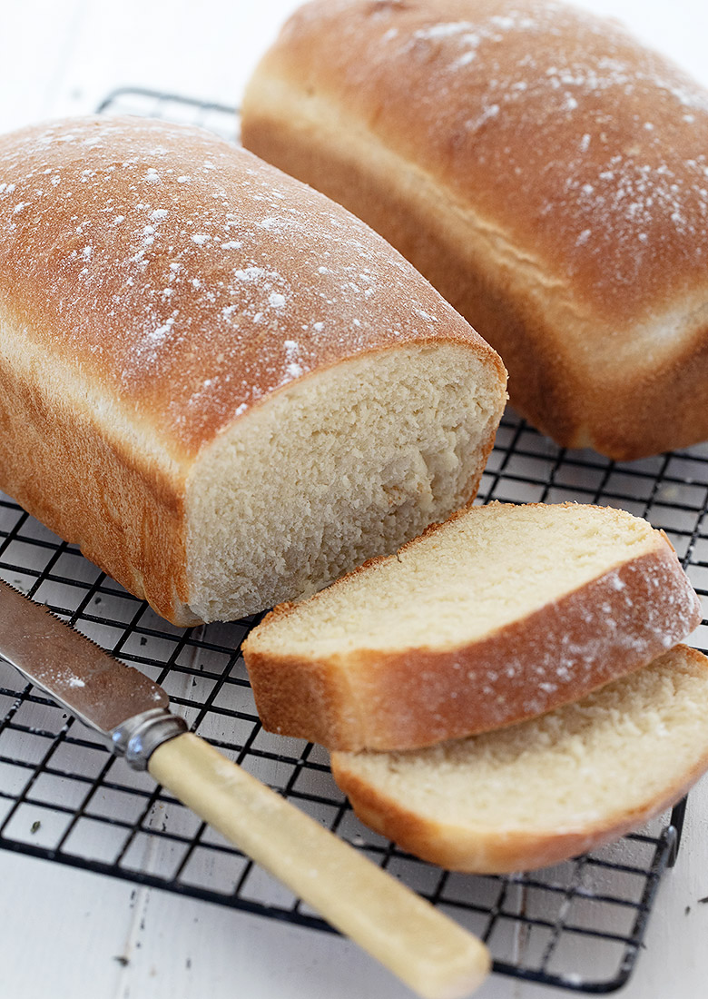 white homemade bread, sliced on cooling rack