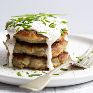 Irish Boxty stacked on plate with sour cream