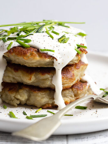 Irish Boxty stacked on plate with sour cream