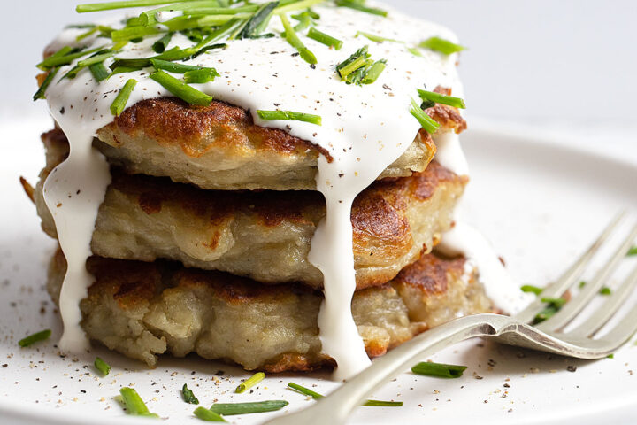 Irish Boxty stacked on plate with sour cream