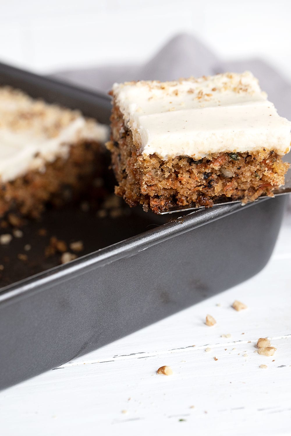 carrot sheet cake in pan with slice out