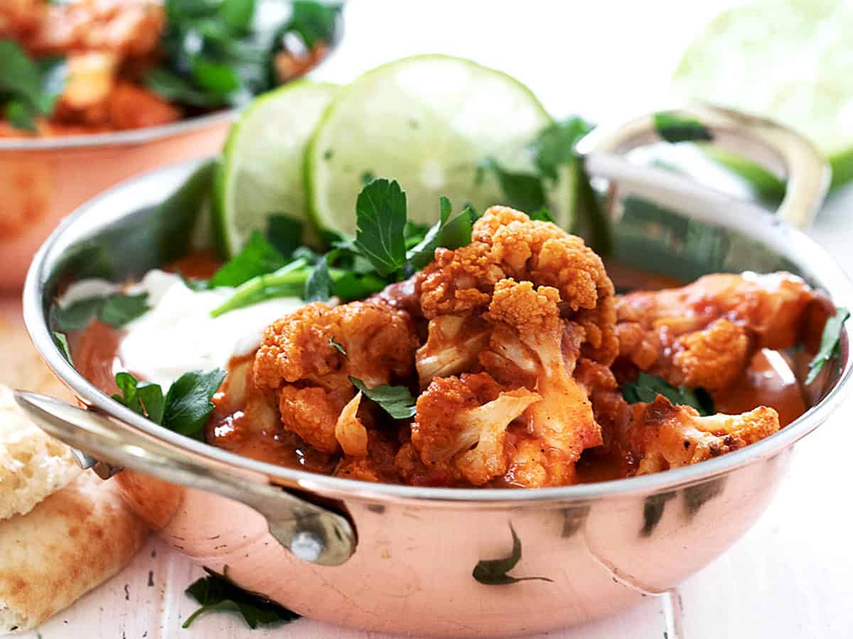 Indian cauliflower curry in copper bowls