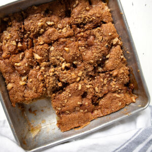 old-fashioned rhubarb cake in pan with a piece out