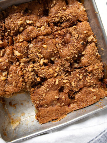 old-fashioned rhubarb cake in pan with a piece out