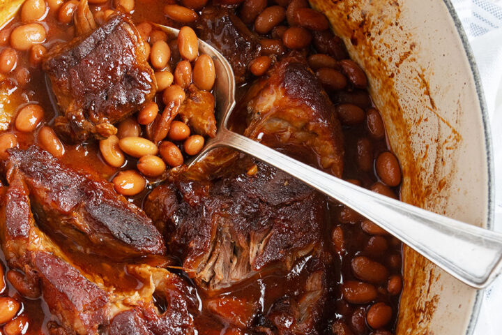 pork and beans in baking dish with spoon