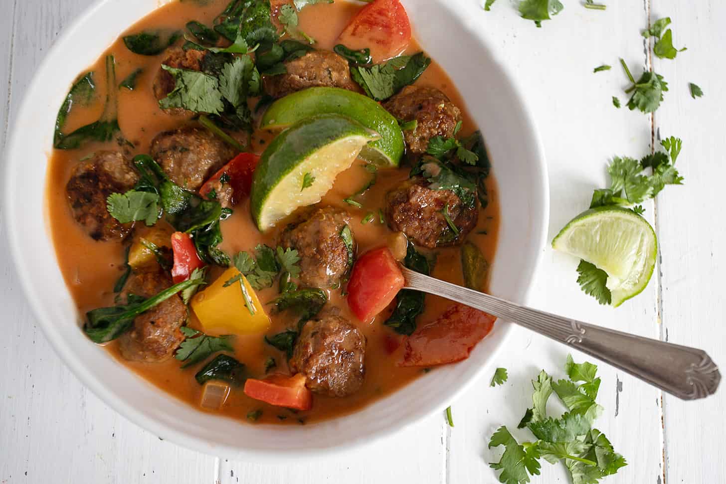 Thai chicken meatball soup in bowl with spoon