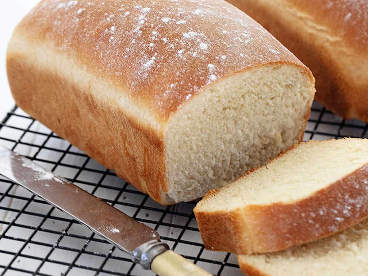 homemade white bread sliced on cooling rack