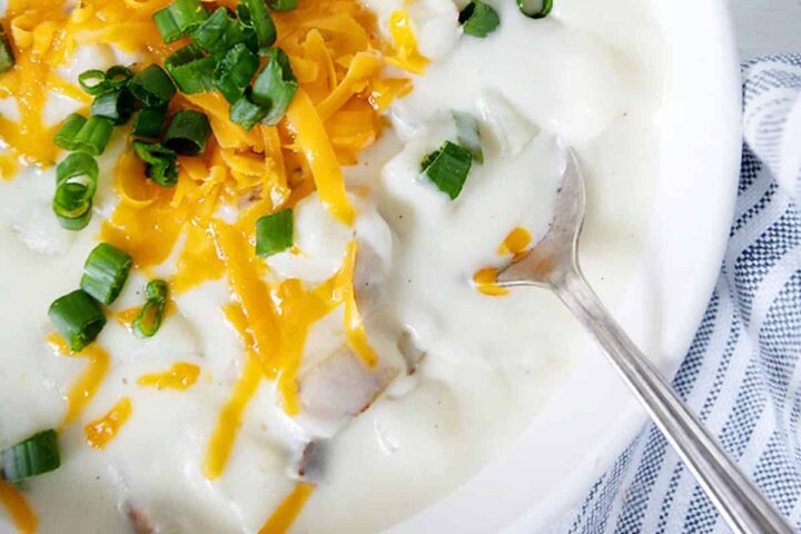 loaded baked potato soup in white bowl