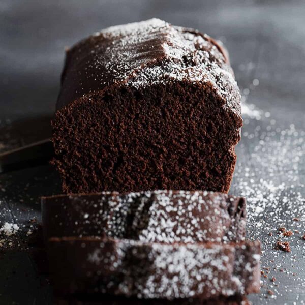 chocolate pound cake sliced with icing sugar