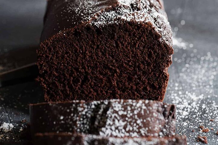 chocolate pound cake sliced with icing sugar