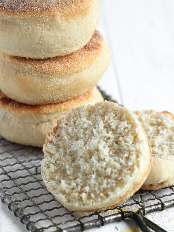 homemade English muffins stacked and split open