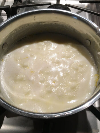 gently simmering the cream in the saucepan