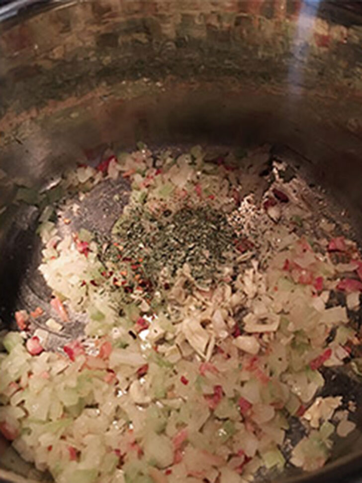 Garlic and herbs added to the pot.
