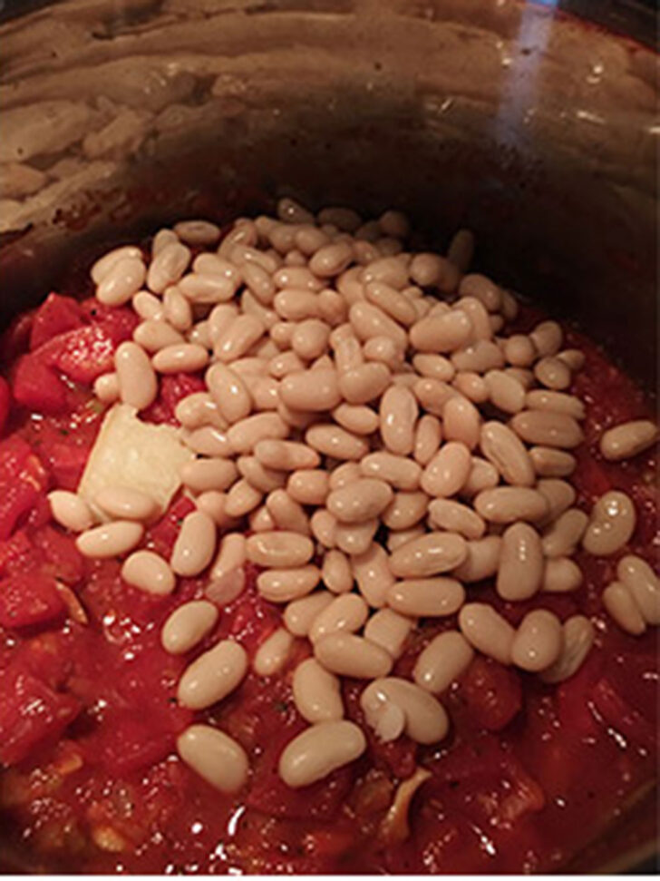 Adding the beans to the pot.
