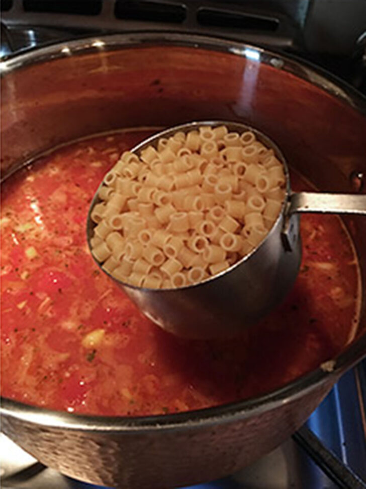 Adding the pasta to the pasta fagioli.