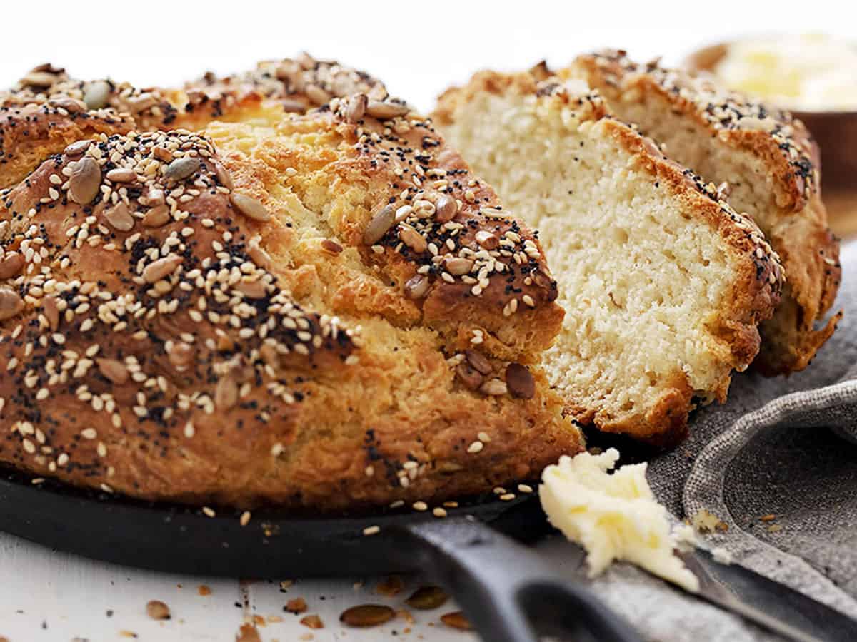 seeded no yeast bread in skillet sliced with butter
