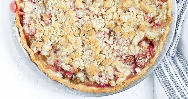 half shot of whole rhubarb crumble pie shot from above