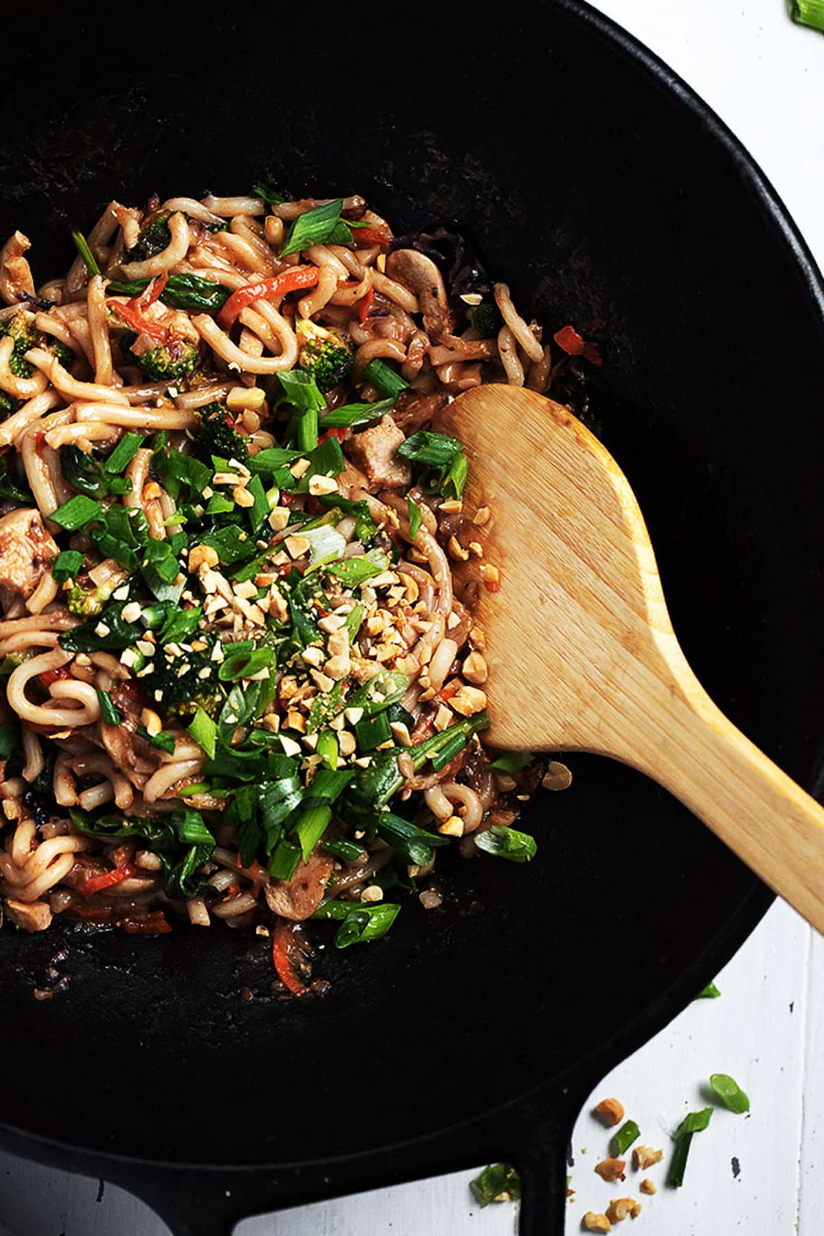 spicy peanut noodles in a cast iron wok