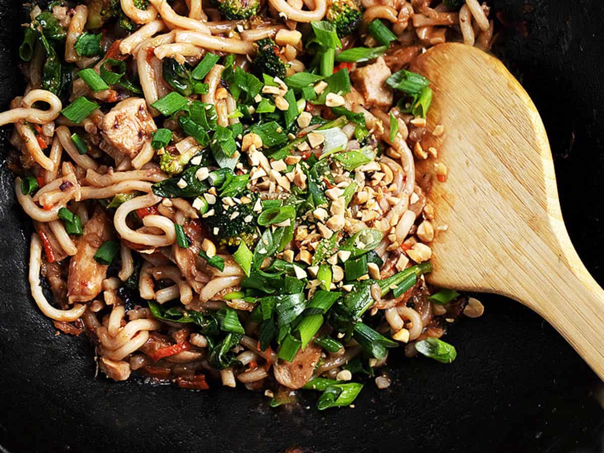spicy peanut noodles in a cast iron wok