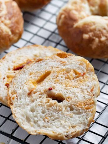 asiago sun dried tomato bagels on cooling rack