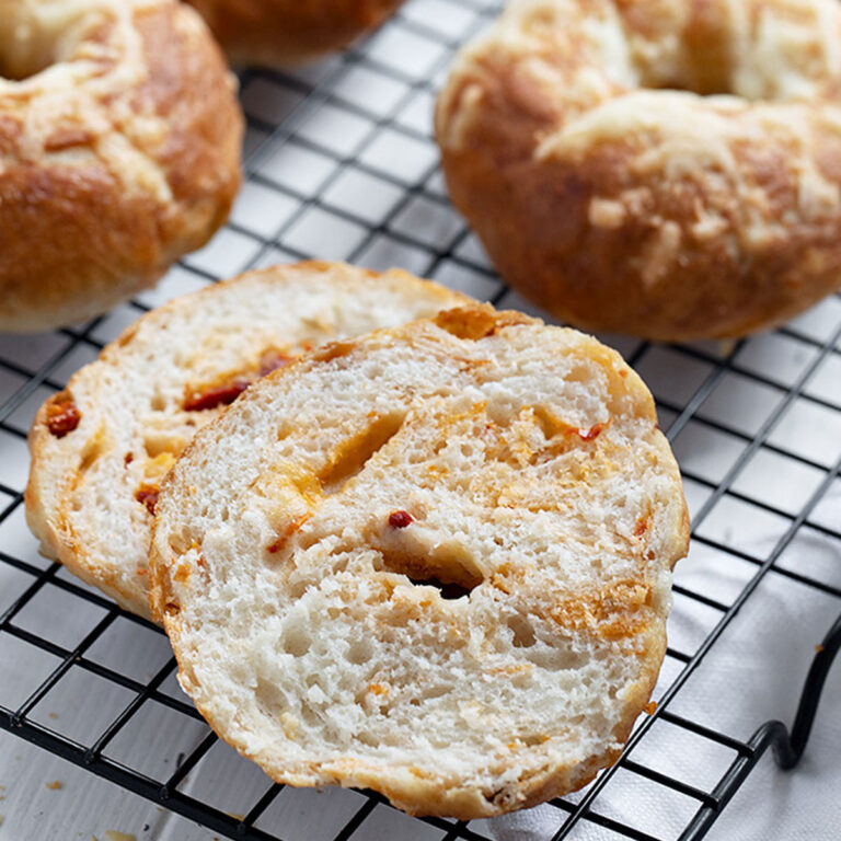 asiago sun dried tomato bagels on cooling rack