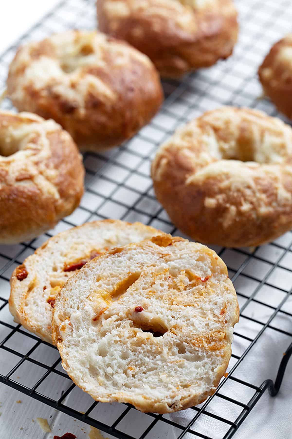 asiago sun dried tomato bagels on cooling rack