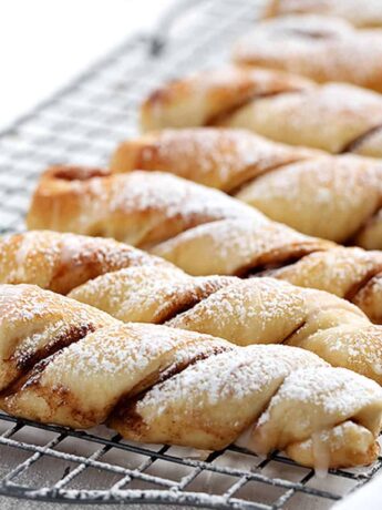 cinnamon twists lined up on a cooling rack in portrait view