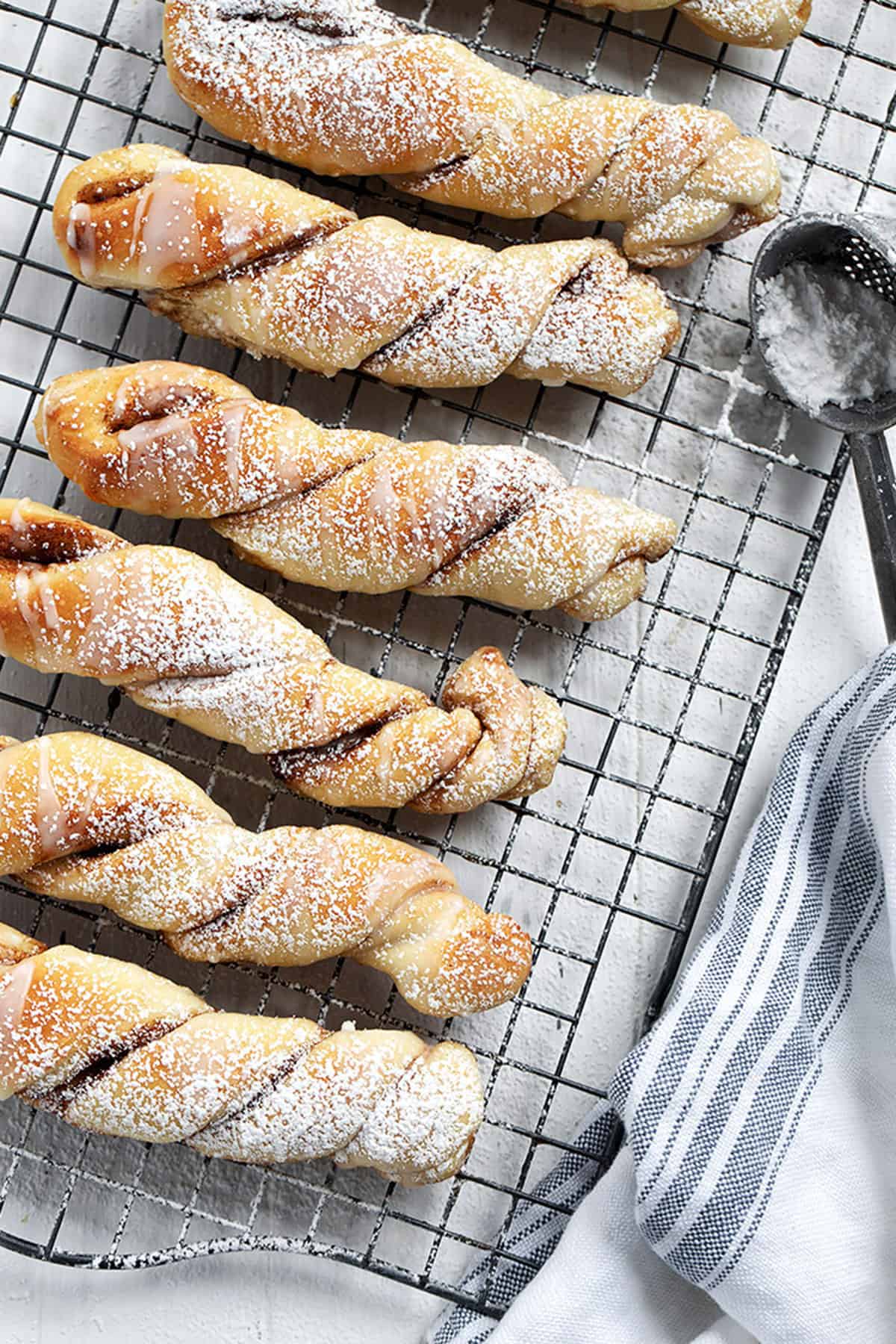 cinnamon twists lined up on a cooling rack in portrait view