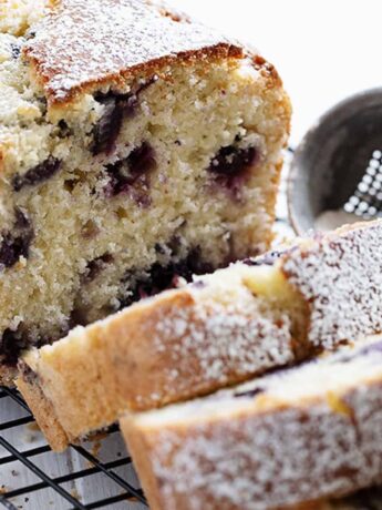 blueberry buttermilk loaf sliced on cooling rack