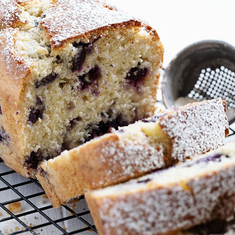 blueberry buttermilk loaf sliced on cooling rack