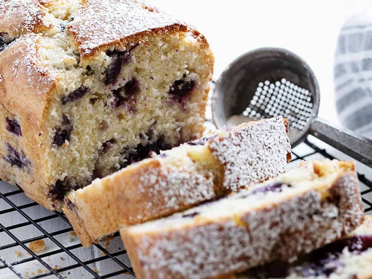 blueberry buttermilk loaf sliced on cooling rack