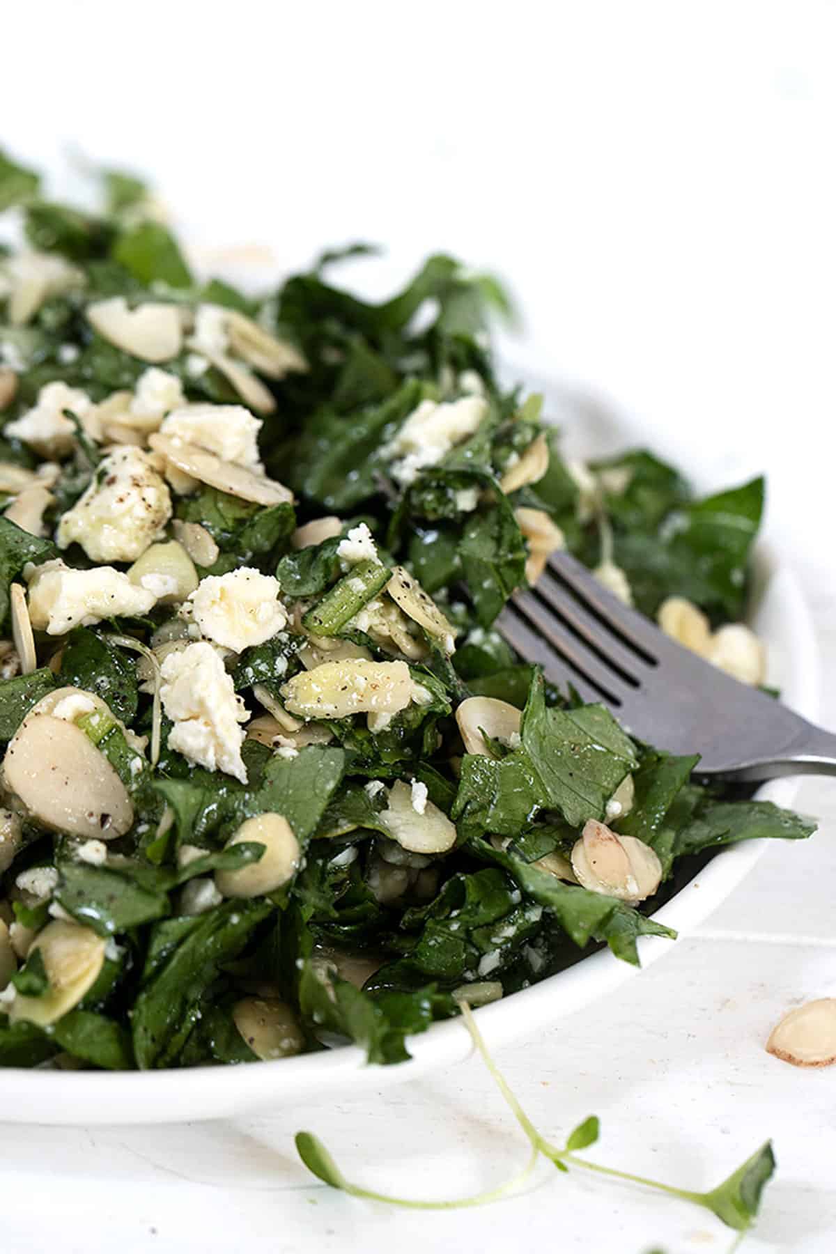 feta almond salad on white plate with fork